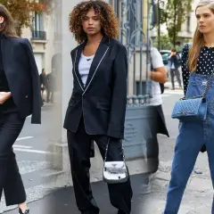 Tres mujeres exhiben su **street style** en la ciudad: una con traje negro, otra con blazer y pantalón, y la tercera con peto vaquero y top de lunares.