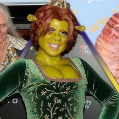 Heidi Klum se disfraza de Fiona de Shrek para Halloween, con un maquillaje verde y orejas características. A su lado, una persona mayor y un tentáculo gigante.