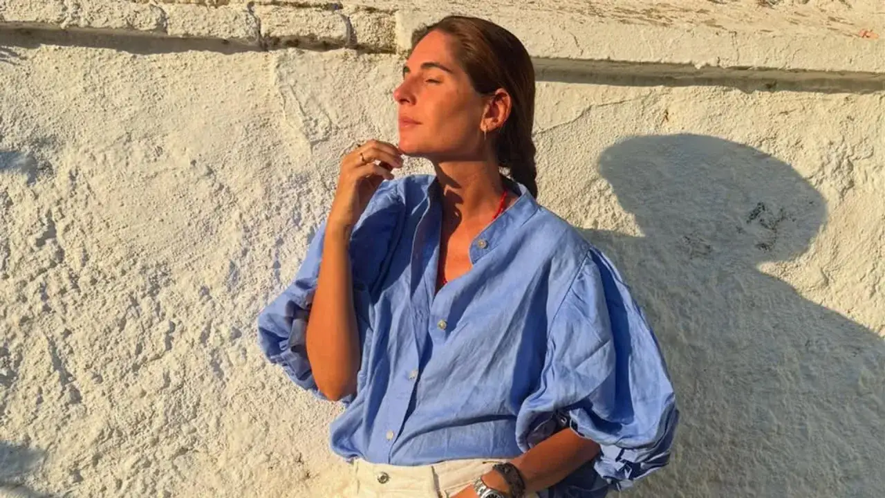 Lourdes Montes disfruta de un atardecer c&aacute;lido, con la luz dorada iluminando su rostro y su blusa azul.